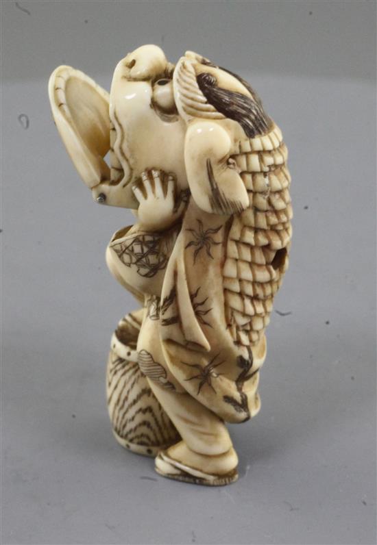 A Japanese ivory netsuke of a shishimai dancer, Meiji period, signed Nagatame, h. 5.1cm